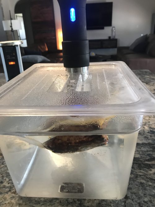 At home sous vide setup in clear plastic tub