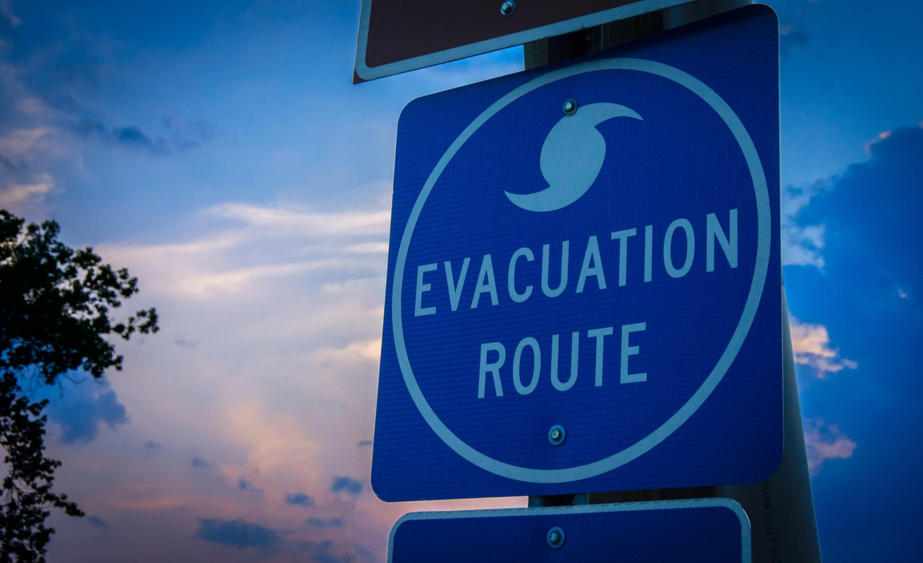 Evacuation route sign -- who gets paid when your office closes due to bad weather?